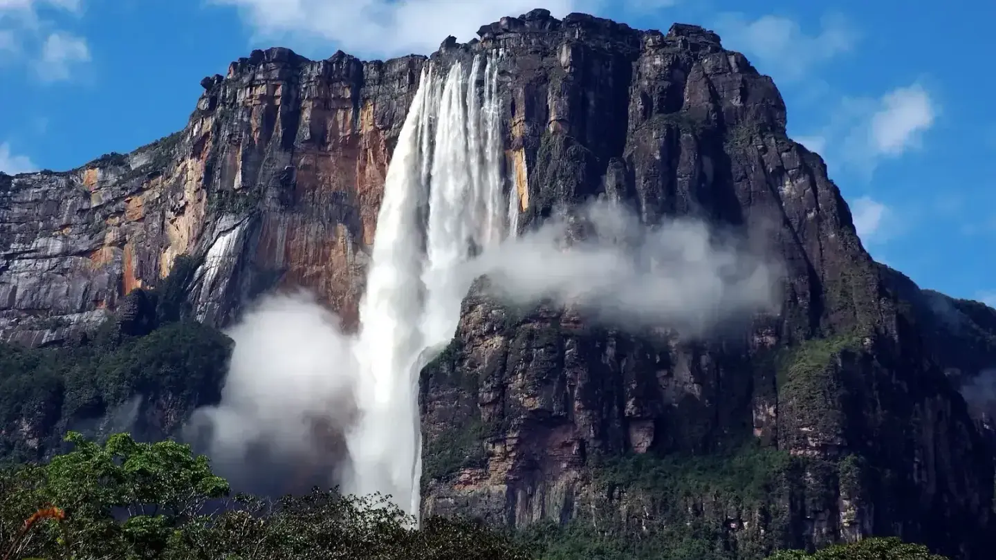 Angel Falls plunging from Auyantepui tepui surrounded by mist in Canaima National Park, Venezuela