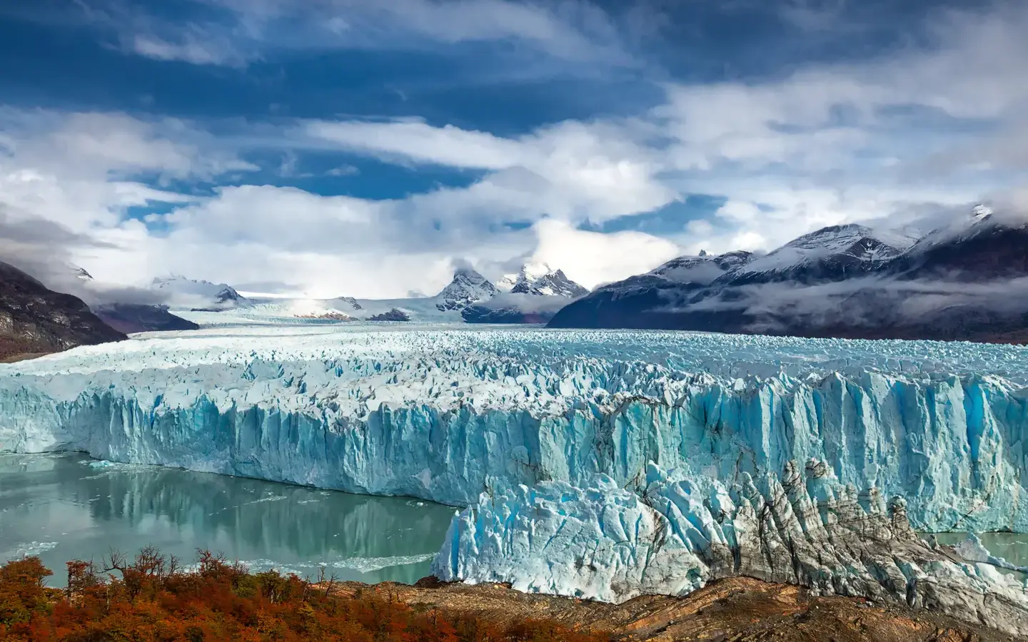 The Perito Moreno glacier meeting Lago Argentino below snow-capped peaks, Los Glaciares National Park, Argentina