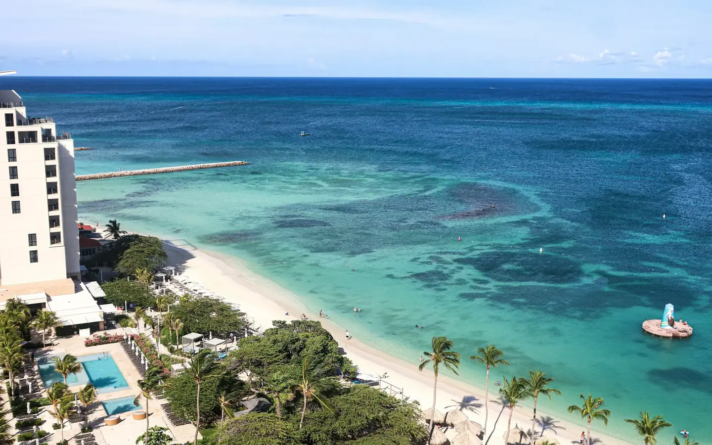 Aerial view of turquoise Caribbean waters and white sand beach in Aruba