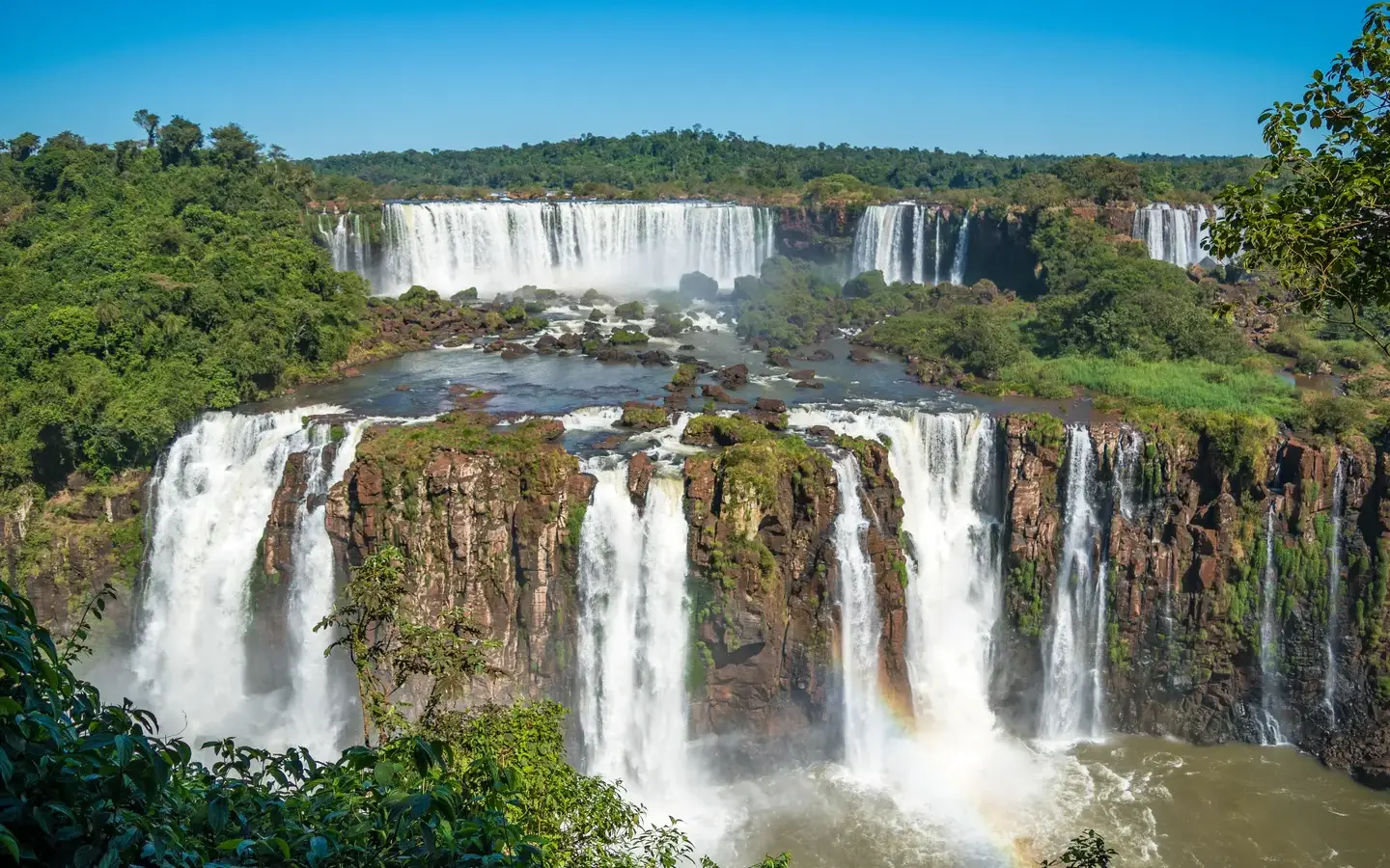 Panoramic view of Iguazu Falls cascading through the rainforest, seen from the Brazilian side