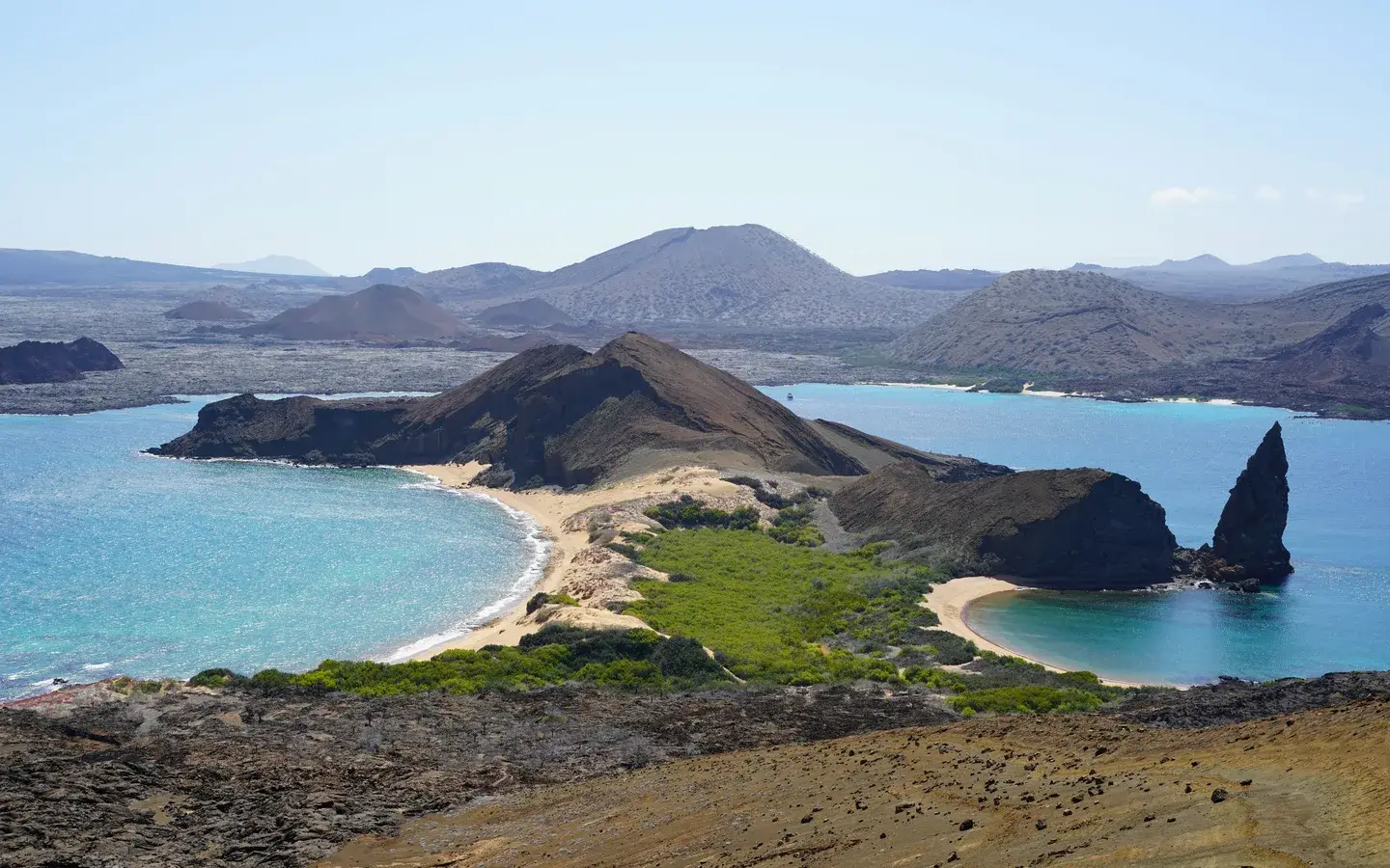 View from the Bartolome Island summit over Pinnacle Rock and twin turquoise bays, Galapagos