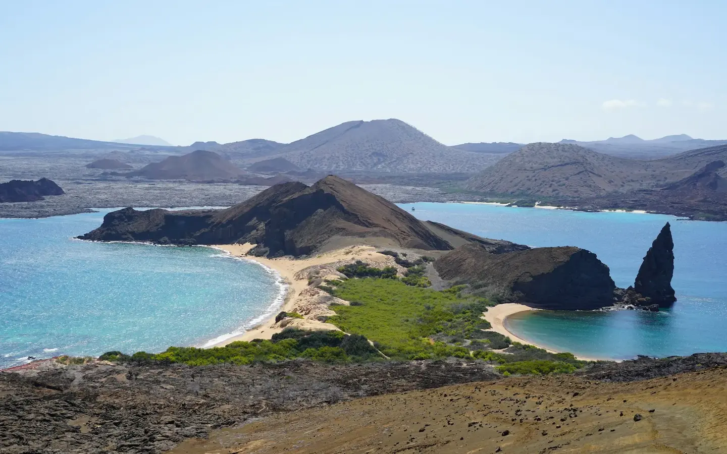 Panoramic view of Bartolome Island with Pinnacle Rock and turquoise bays in the Galapagos Islands