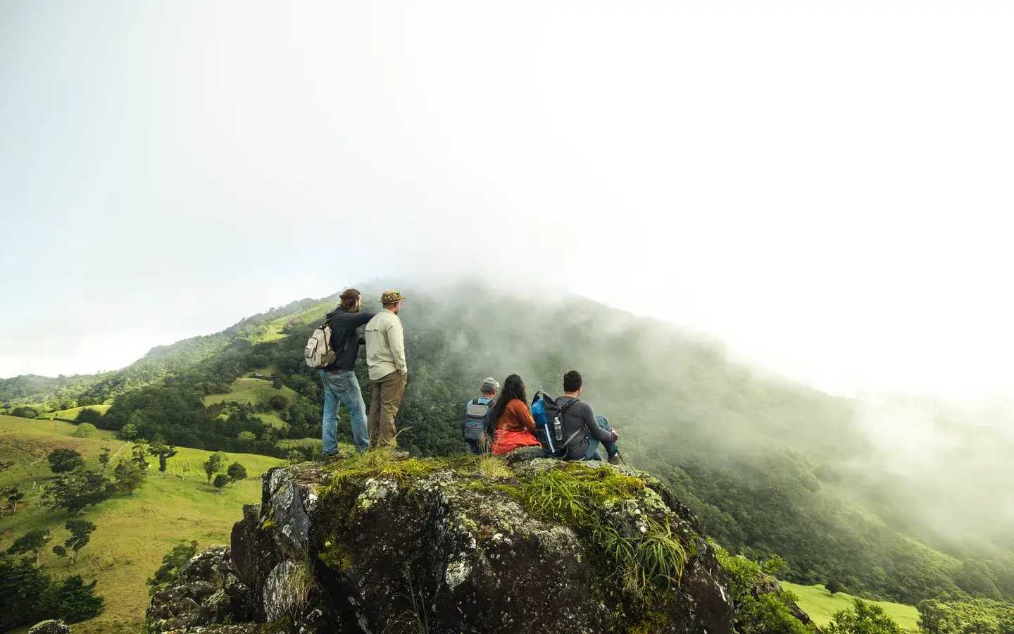 Hikers watching cloud pour over the green ridges of Cerro Artillería above Boquete, Chiriquí, Panama