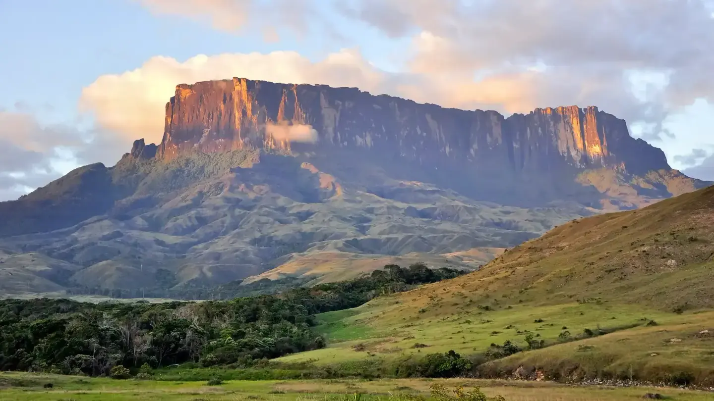 Golden sunset light casting dramatic shadows across Mount Roraima's cliff face in Venezuela