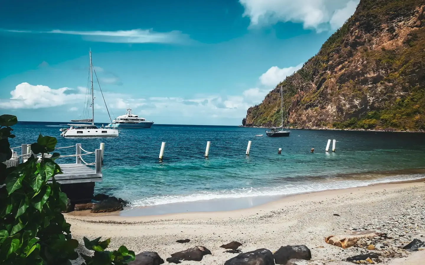 Beach with yachts anchored beneath the Pitons on the Caribbean coast of Saint Lucia